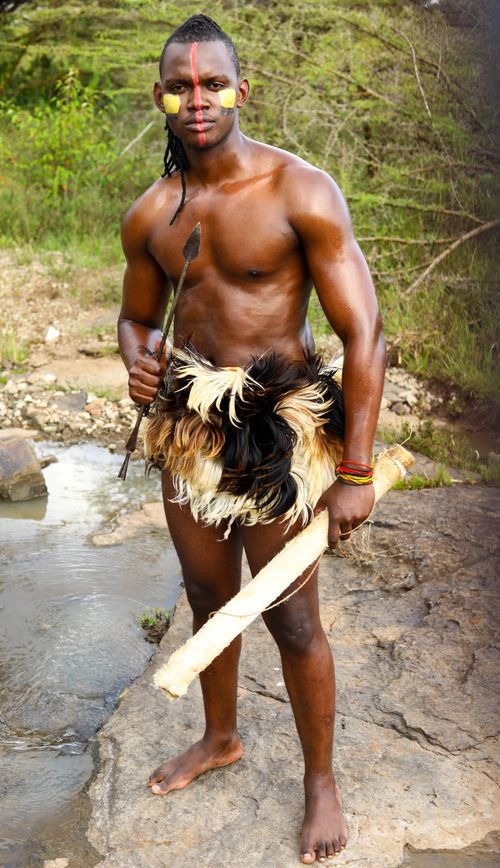 Free Portrait of a tribal man in traditional attire standing outdoors with natural background. Stock Photo