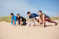 Couples Getting Ready to Run on the Sand