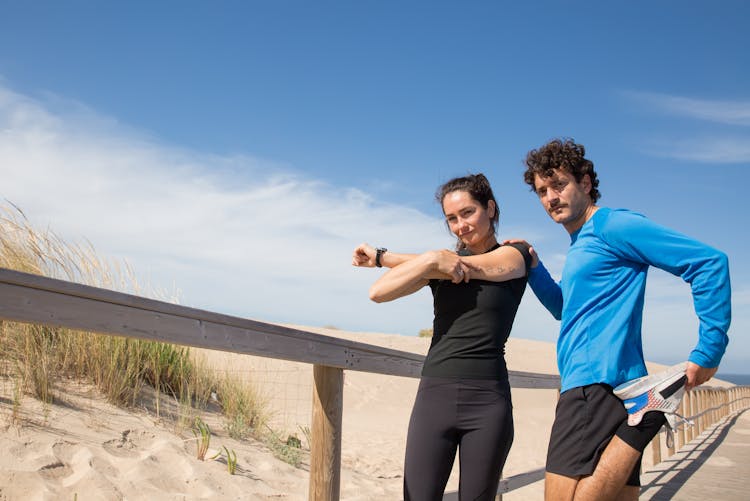 Man And Woman Doing Warm Up Exercise