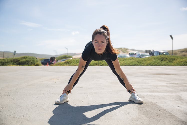 Woman In Black Activewear Doing Bending Exercise