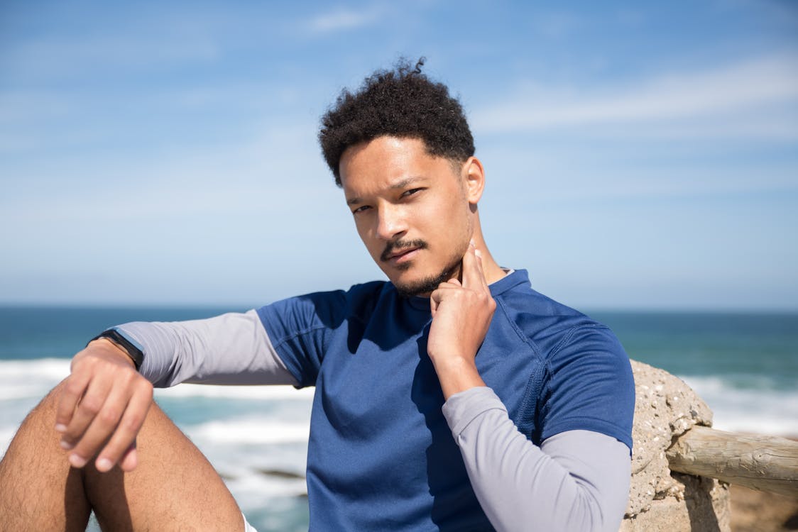 Man in Blue Shirt Checking His Pulse