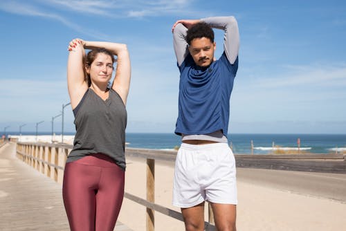 Free Man and Woman Stretching Stock Photo