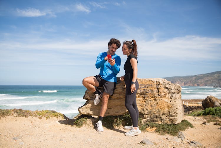 Man Showing His Phone To A Woman