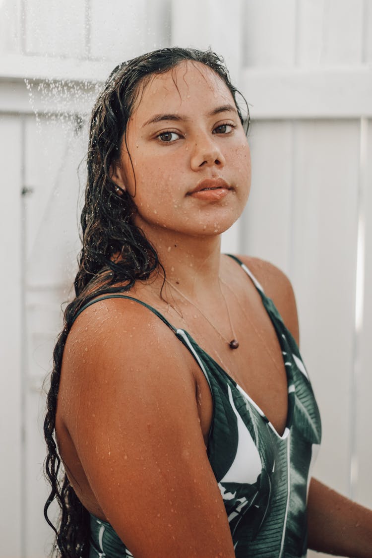 Woman In Green Swimsuit Taking A Shower
