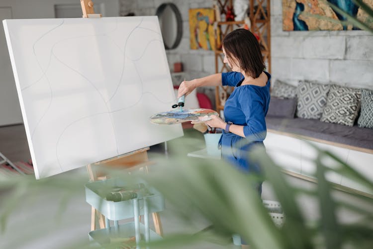 Woman Putting Paint On A Palette 