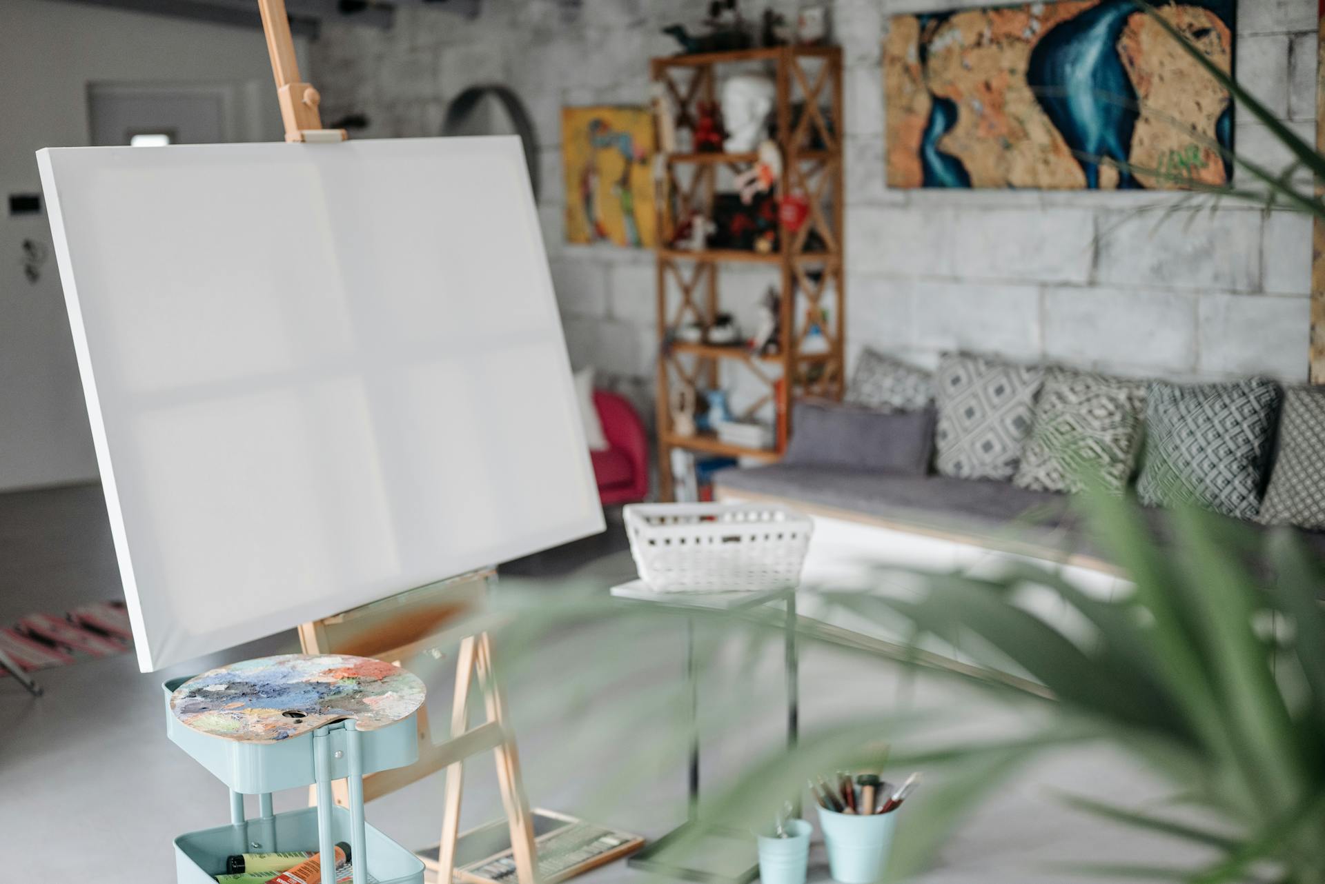 Blank Canvass on the Stand Near a Color Palette