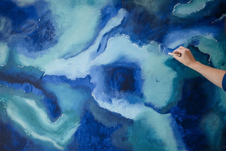 Close-up Of Person Creating A Blue Abstract Painting 