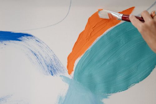 Free Close-up of a hand painting vivid brush strokes on a canvas. Perfect for art themed content. Stock Photo