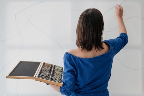 Back View of Artists Drawing and Holding a Case with Pencils 