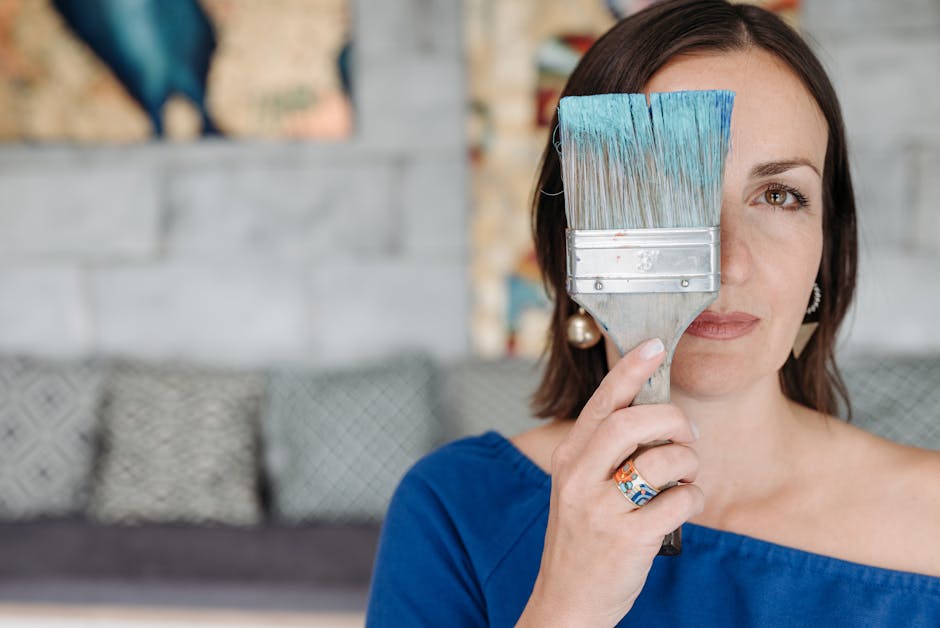 Woman Covering Face with a Large Paint Brush