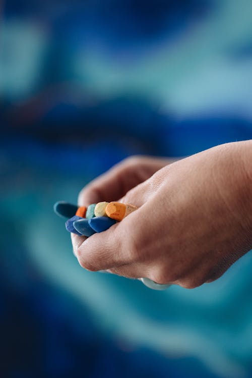 Free Hands of a Person Holding Crayons
 Stock Photo
