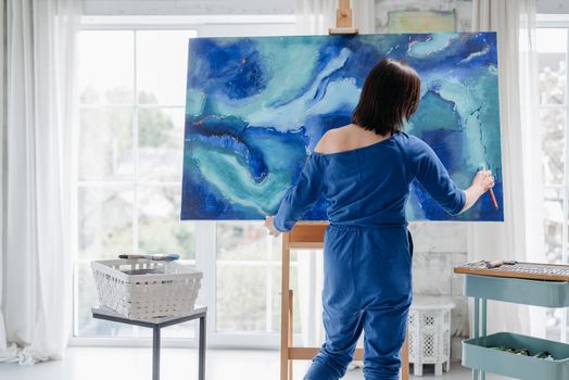 A Woman Doing a Canvass Painting