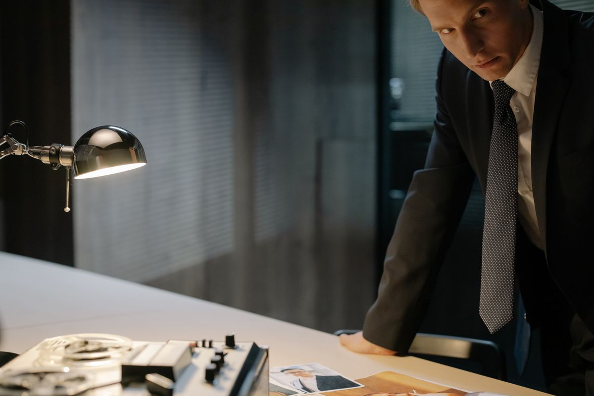 Investigator laying out case material on a table under a lamp