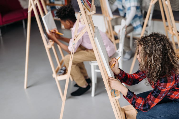 Students In The Classroom Drawing On A Canvas