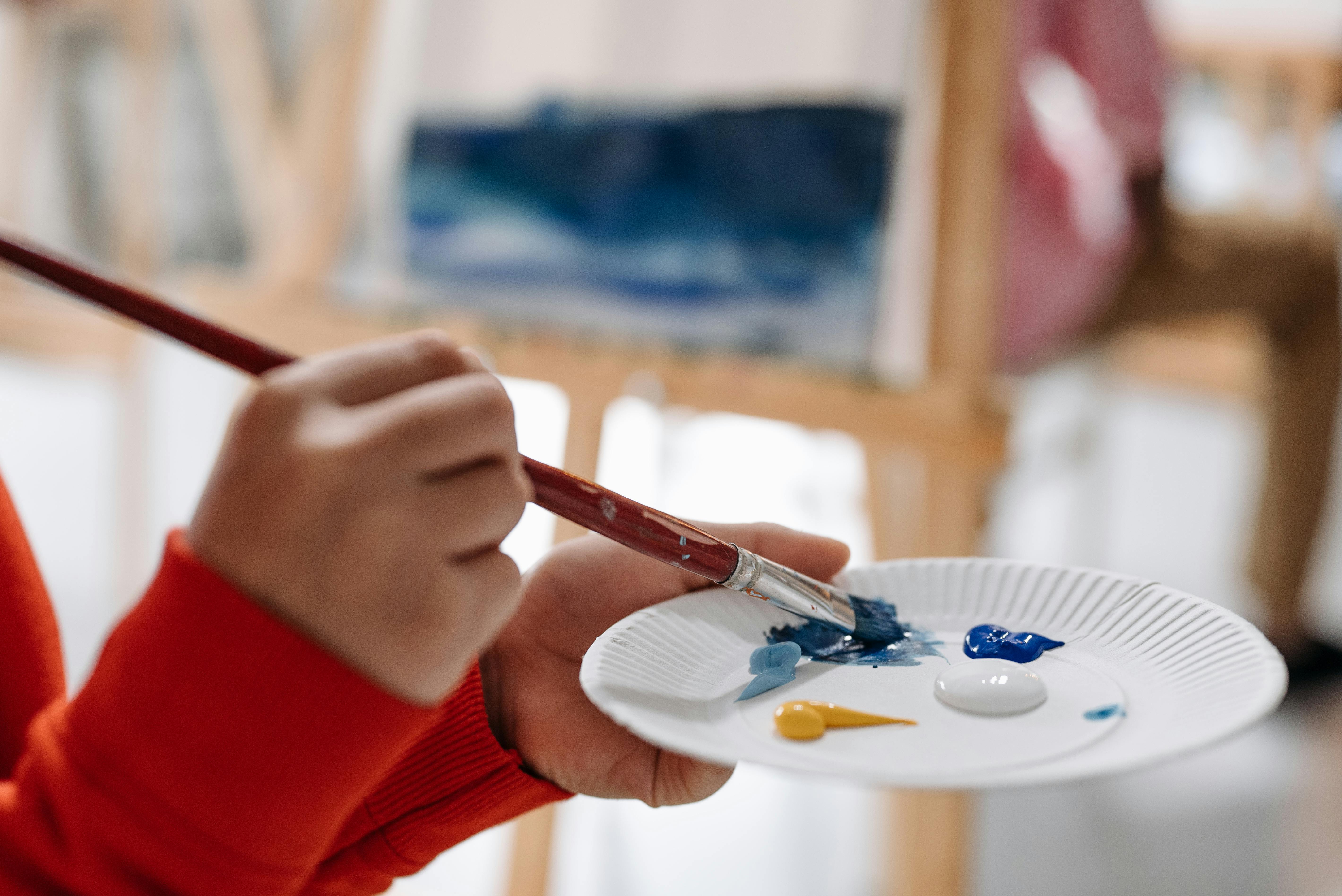 Close-Up Shot of Two People Painting the Wall Brown · Free Stock Photo