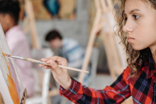 Free A Girl Holding a Paint Brush Stock Photo