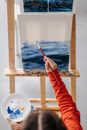 Person Holding Paint Brush and Paint Brush