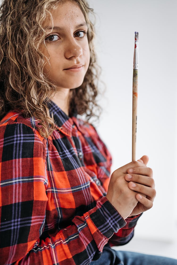 Girl In A Shirt Holding A Paintbrush 