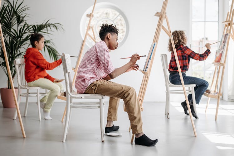 Children Painting On Canvases