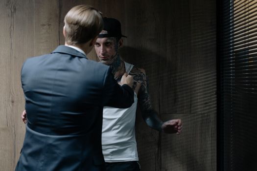 Detective Holding a Man against a Wall 