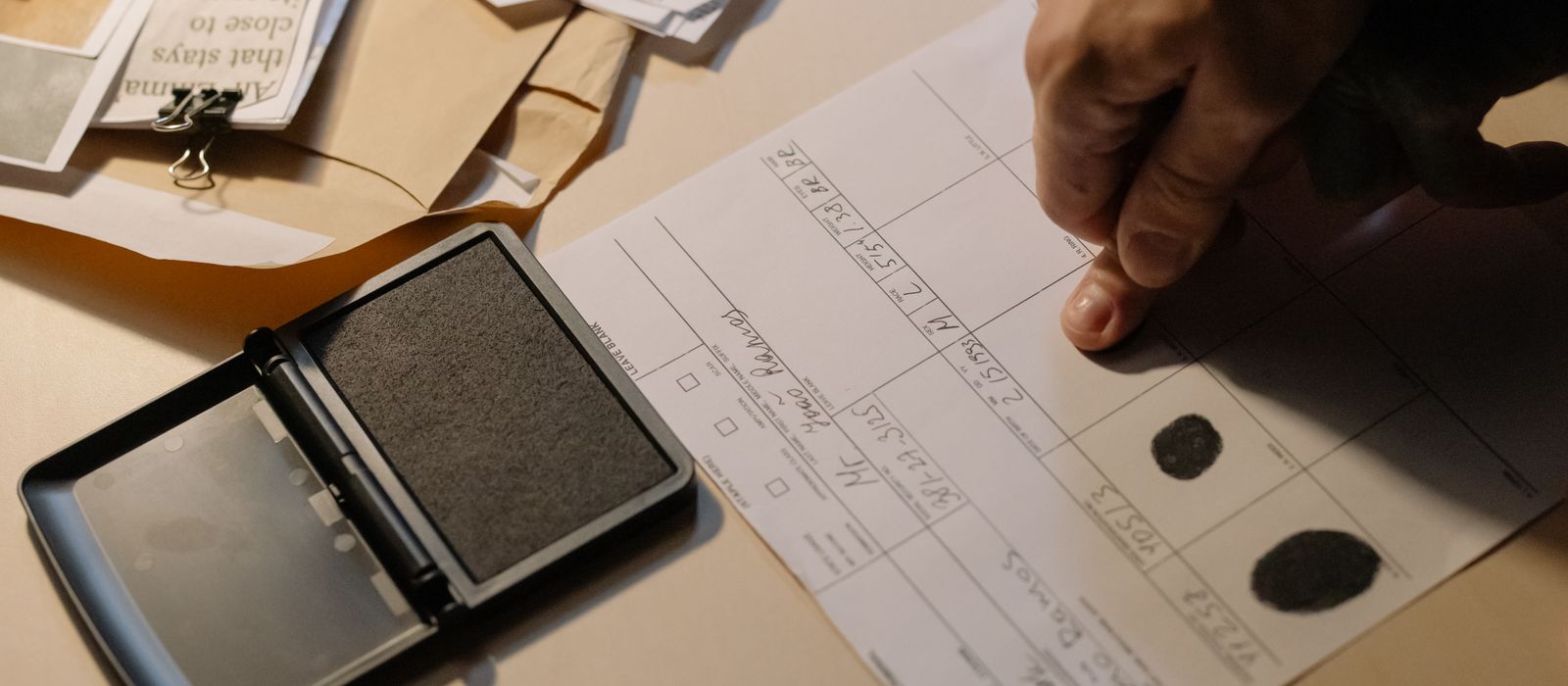 A thumb impression being placed on a form