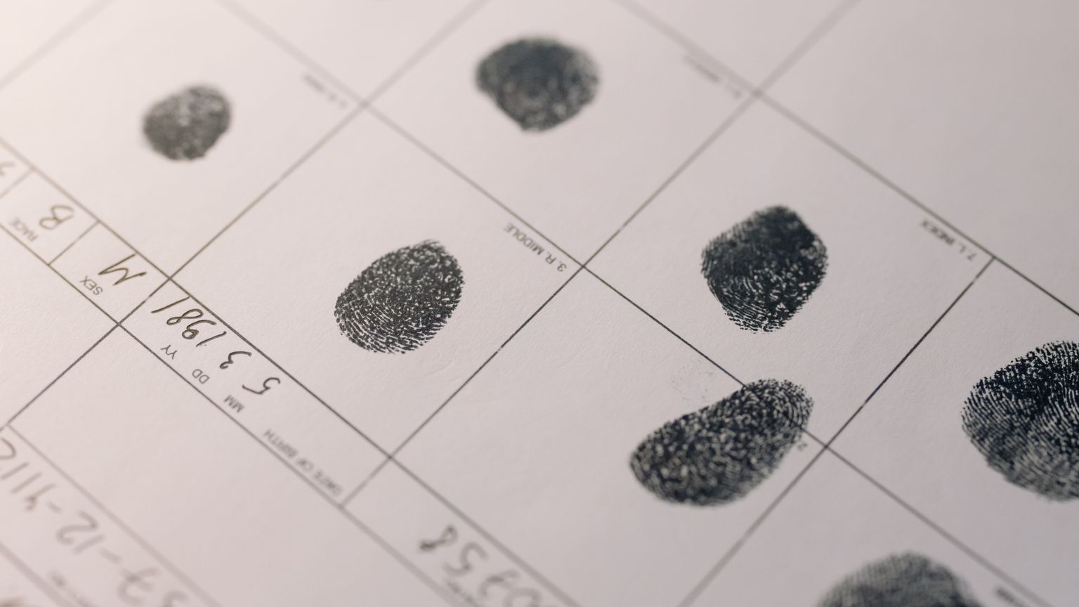 Inked fingerprints recorded on an official identity verification form