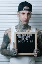 Man in White and Brown Crew Neck T-shirt Holding Black and White Quote Board