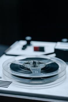 Close-up of a classic reel-to-reel tape recorder showcasing retro audio technology.
