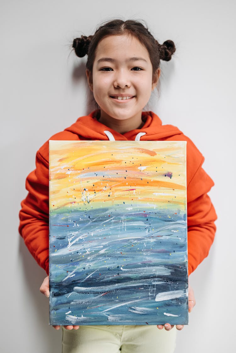 Smiling Girl Holding A Painting 