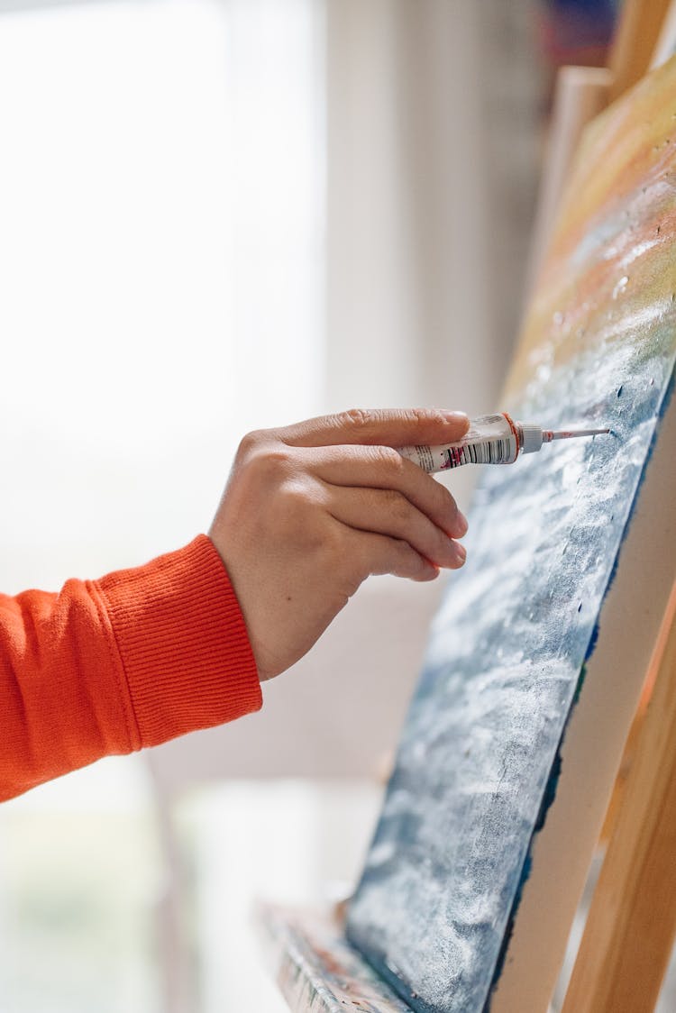 A Person Painting On Canvass