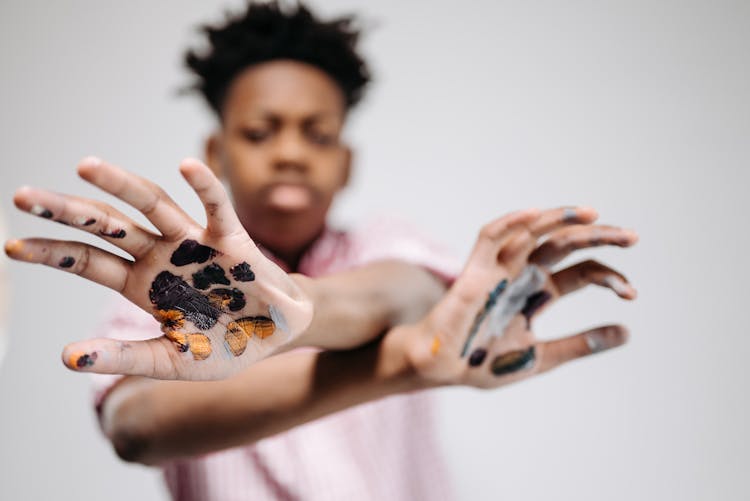 A Black Paint On Person's Hands