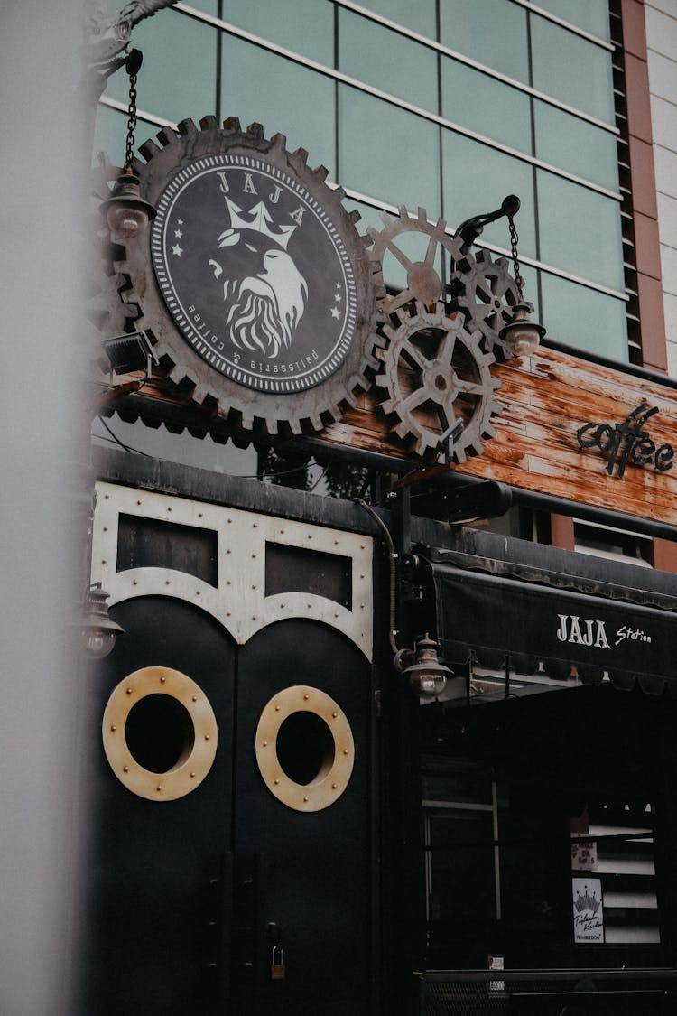 Logo With Gears On Entrance To Pub