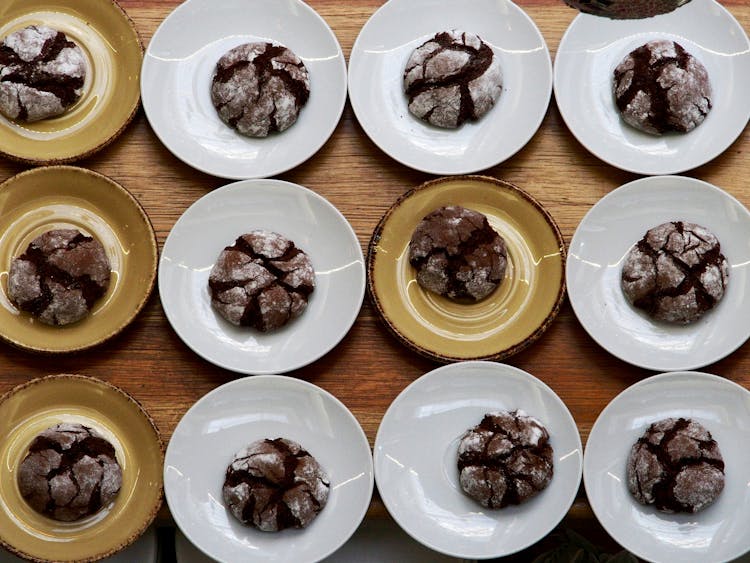 Overhead Shot Of Chocolate Crinkle Cookies In Saucers