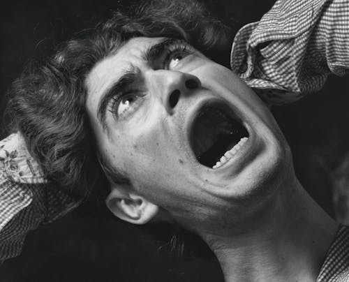 Grayscale Photo of a Man Open his Mouth