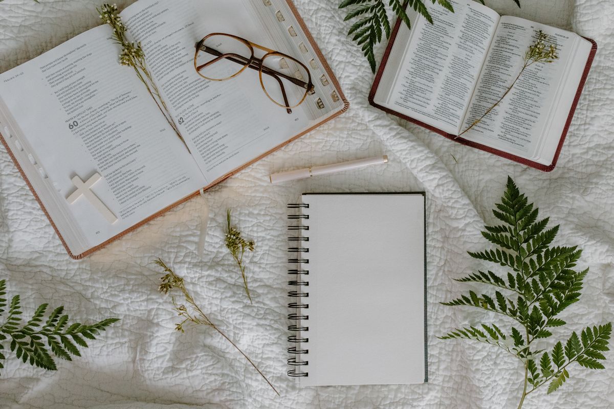 Bible and notebook representing the origin of Daily Divine Bread