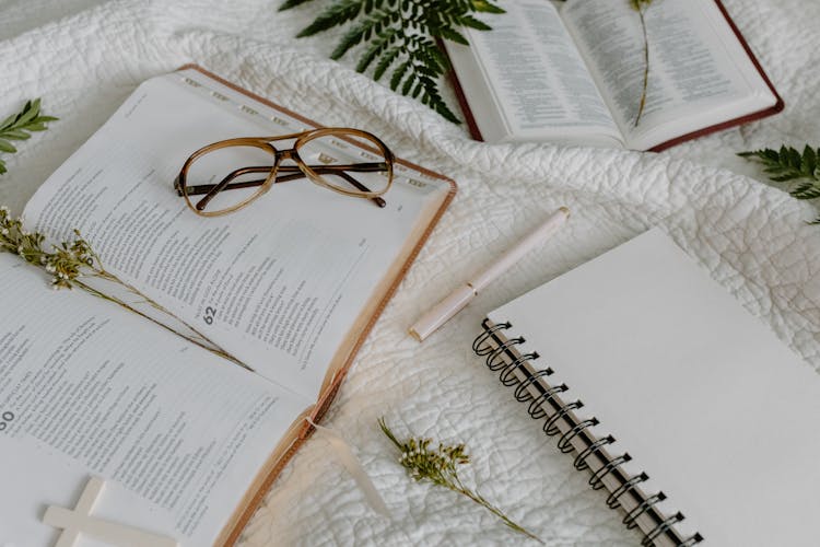 Sacred Scriptures And A Notebook On A Cloth