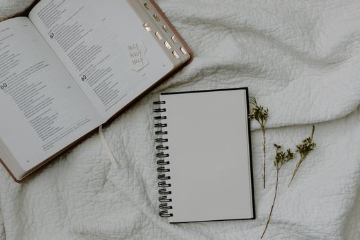 White Spiral Notebook on White Textile