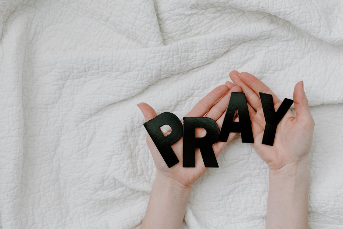 Free A Person Holding a Black Letters Stock Photo