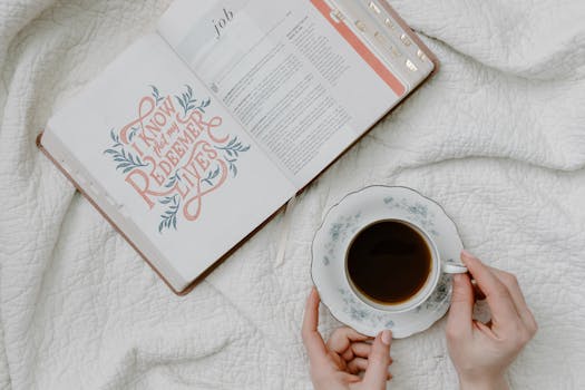 An open Bible with a quote and coffee, embodying a serene morning routine.