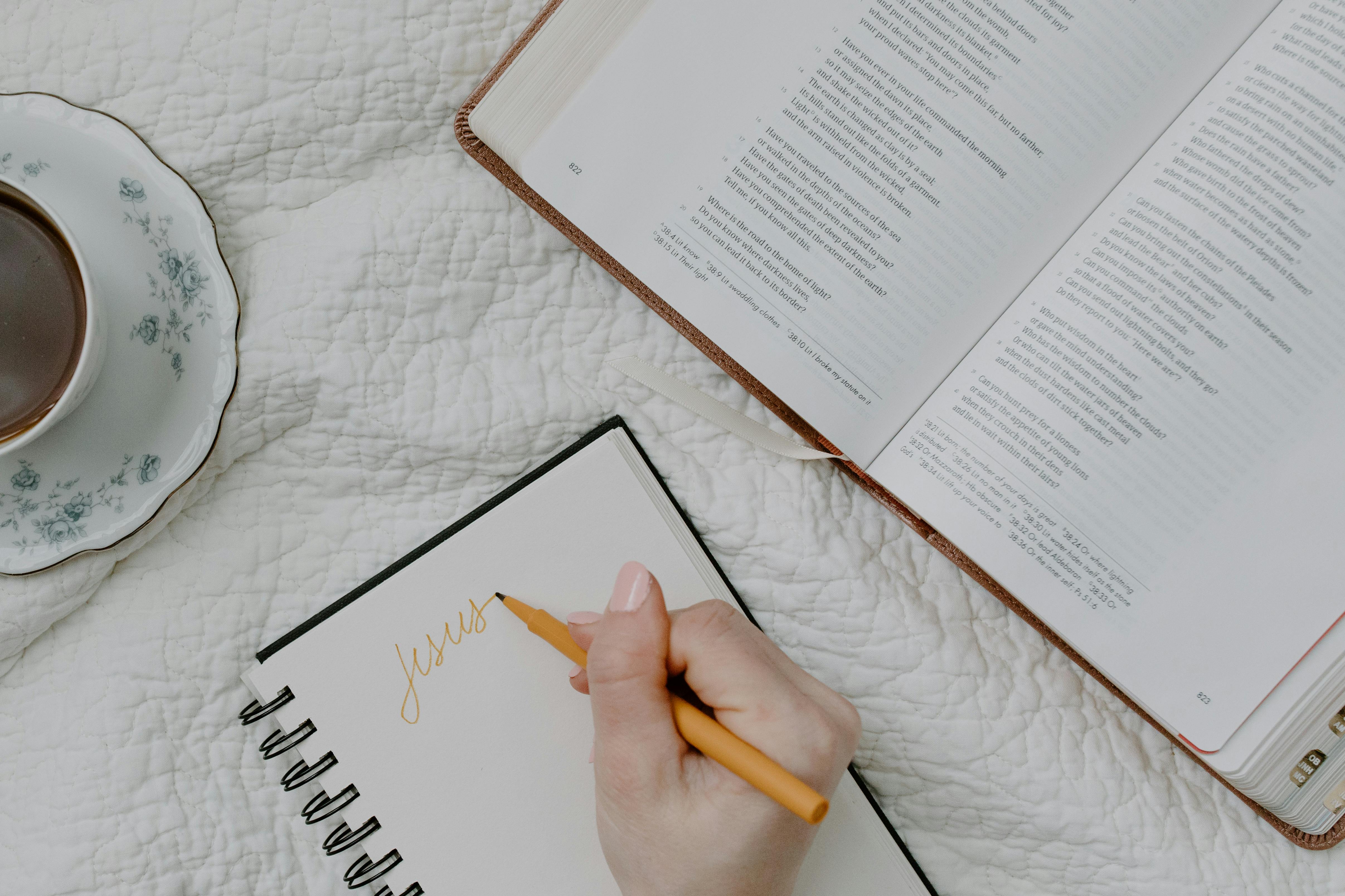 person writing on a notebook