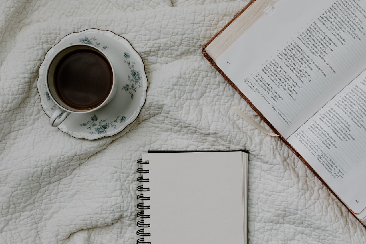 Bible, notebook and coffee ready for a consultation