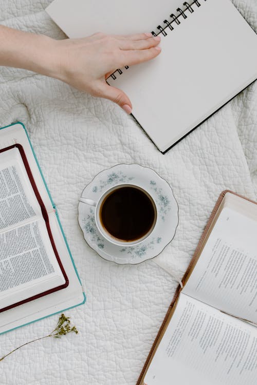 Free Cup of Coffee Beside Open Books Stock Photo