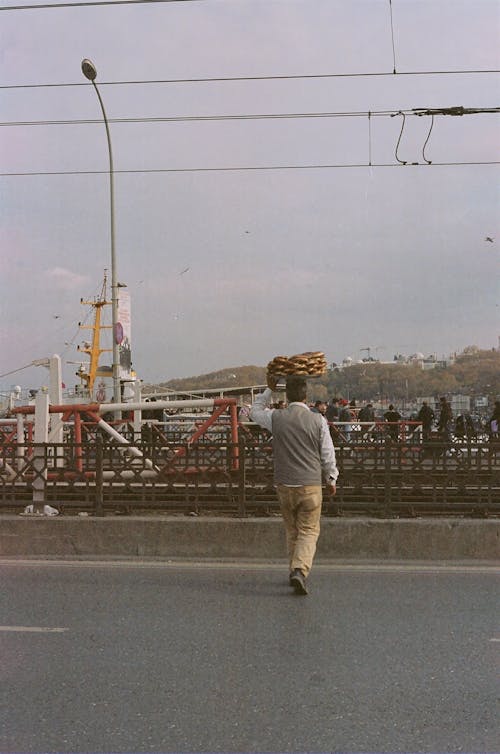 Man Carrying a Tray of Bread on His Head