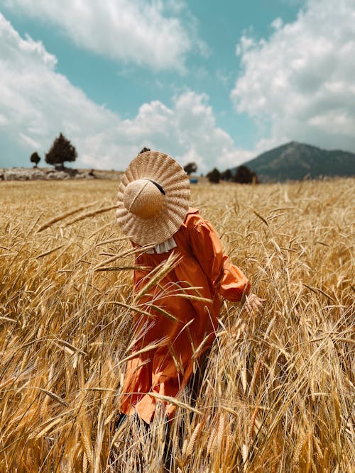 Woman in the Middle of a Grass Field