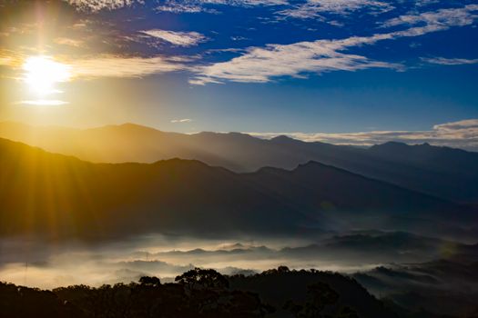 Stunning sunrise over misty mountains, capturing nature's beauty and tranquility in vibrant tones.