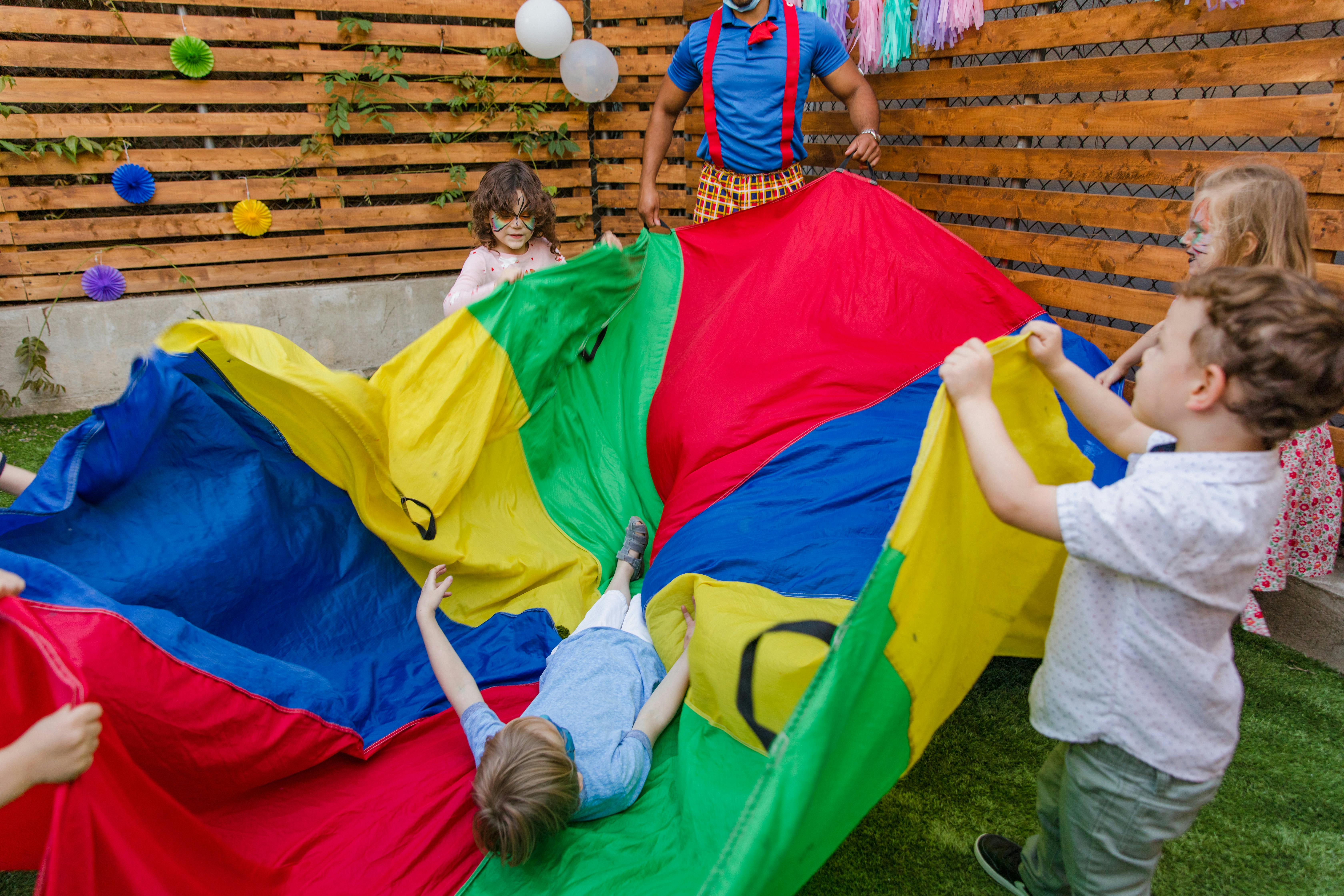 children playing with a colorful parachute