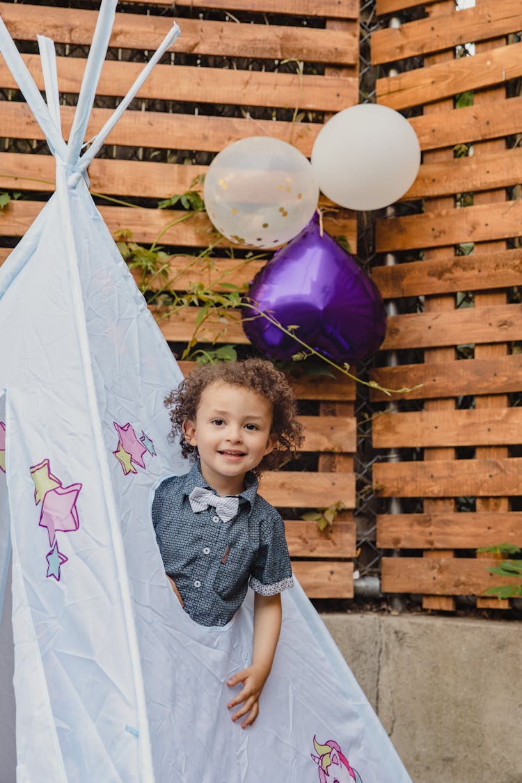 Cute Kid Playing On A Teepee