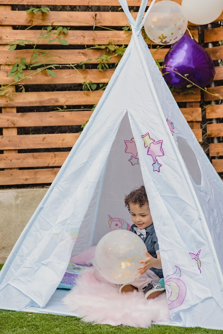 A Kid Inside A Teepee Tent