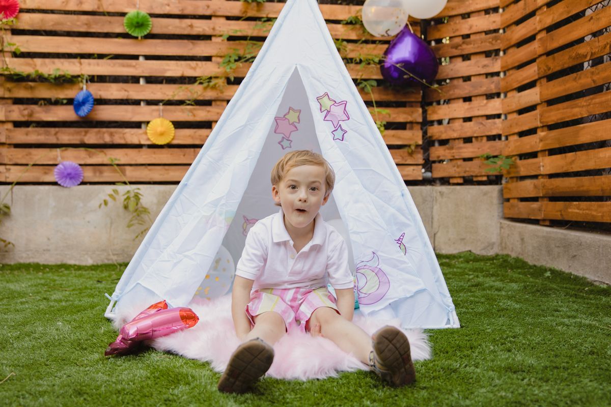 Child enjoying an outdoor garden party during scavenger hunt games