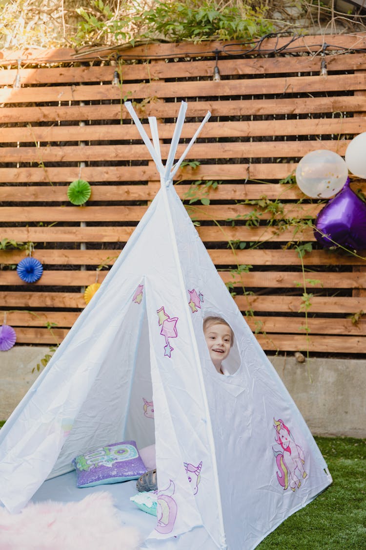  A Child Playing Inside A Tent